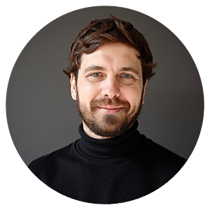 Smiling man in black turtleneck